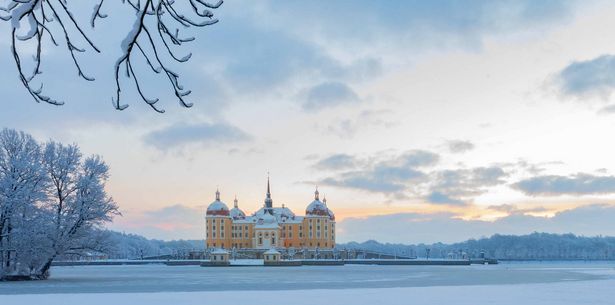 Moritzburg Castle covered in snow in winter.